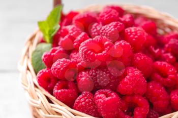 Wicker basket with fresh raspberries, closeup�