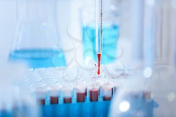 Dripping of blood into test tubes in laboratory�