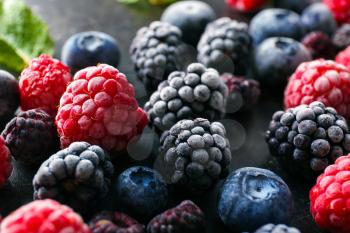 Delicious frozen berries on grey background, closeup�