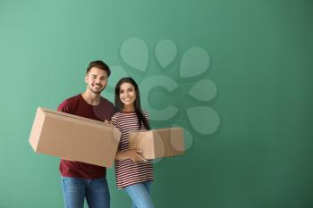 Young couple with moving boxes at new home�