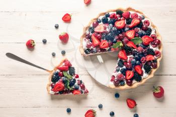 Delicious berry pie on white wooden table�