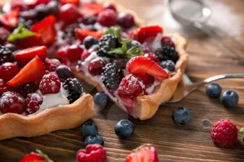 Delicious pie with ripe berries and piece on shovel, closeup�