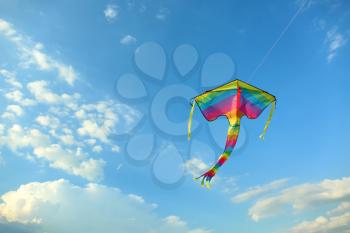Colorful kite flying in blue sky�