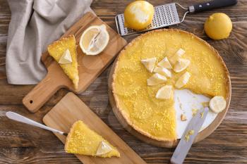 Composition with tasty lemon pie on wooden background�