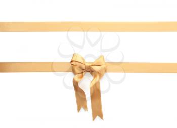 Golden ribbons with bow on white background�