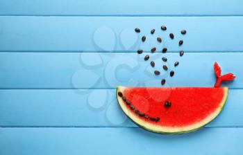 Cute whale made of delicious watermelon slice on wooden background�