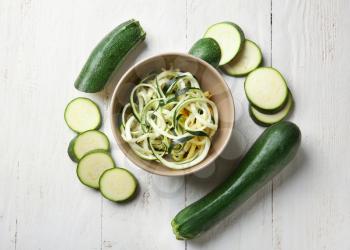 Composition with zucchini spaghetti on table, top view�