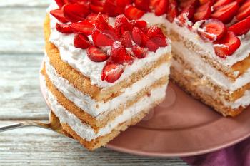 Taking of delicious strawberry cake from plate by using shovel, closeup�