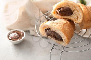 Tasty croissant with chocolate cream on cooling  rack�