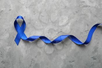Blue ribbon on grey background. Cancer concept�