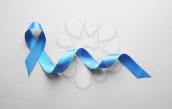 Blue ribbon on light background. Cancer concept�