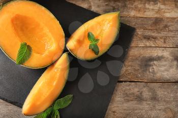 Tasty ripe melons on table�