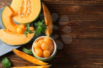 Composition with tasty melon on wooden table�