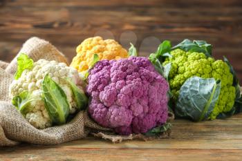 Colorful cauliflowers on wooden table�