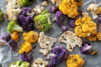 Grilled colorful cauliflowers on parchment�