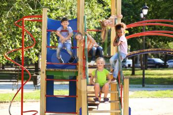 Cute little children having fun on playground outdoors�