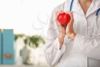 Cardiologist with red heart in clinic�