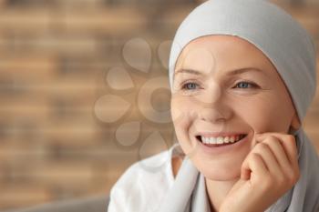 Portrait of happy woman after chemotherapy on blurred background�
