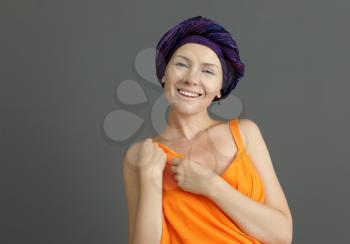 Woman after chemotherapy on grey background�
