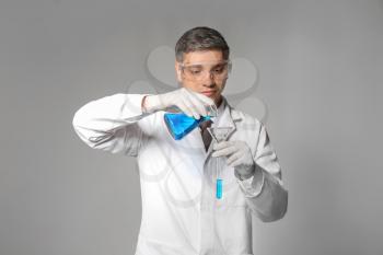 Scientist with test sample on grey background�
