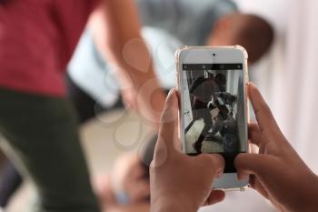 Teenager taking video of bullying boy with mobile phone at school, closeup�
