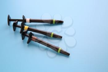 Syringe of esthetic filling material on color background�