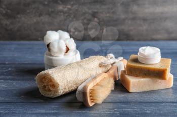 Bath products with loofah and brush on dark wooden table�