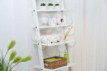 Shelving unit with bath accessories and cosmetics indoors�