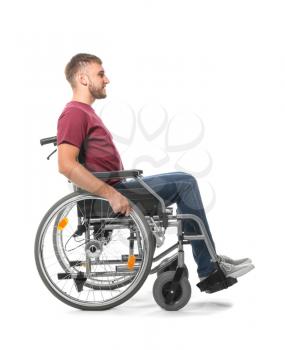 Young man in wheelchair on white background�