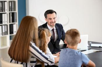 Young woman and her children meeting with headmaster at school�
