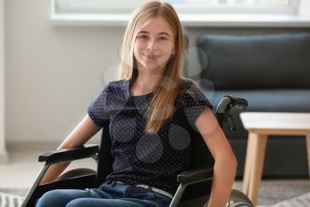 Teenage girl in wheelchair at home�