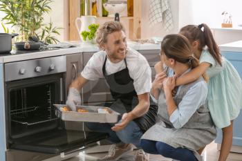 Happy family cooking together in kitchen�