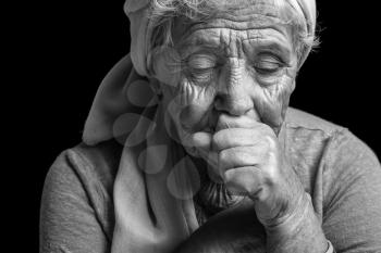 Depressed elderly woman on dark background�