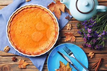 Composition with tasty pumpkin pie on wooden table�