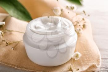 Jar with natural body cream on table�