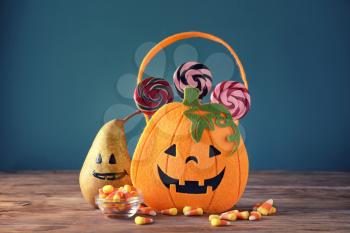 Halloween composition with sweets on wooden table�