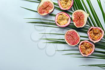 Summer composition with tropical fruits and palm leaf on white background�