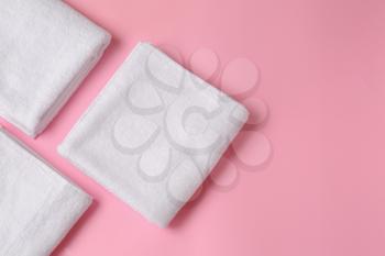 Clean soft towels on color background�