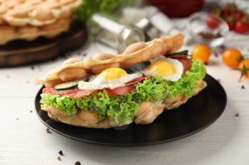 Delicious bubble waffle with fried eggs on plate�