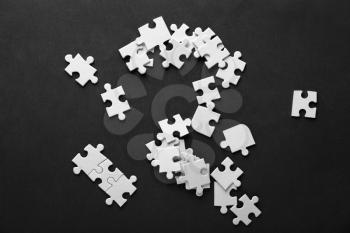 Pieces of jigsaw puzzle on color background�