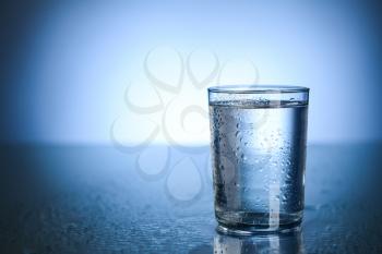 Glass of fresh cool water on table�