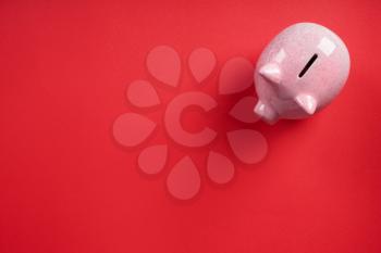 Cute piggy bank on color background�