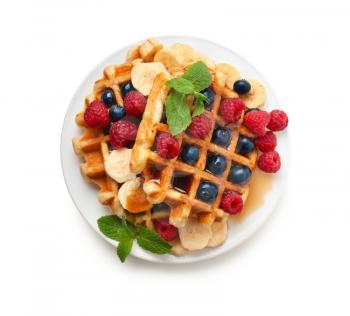 Plate with tasty waffles, fruit and berries on white background�