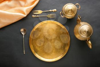 Golden tableware on black background�
