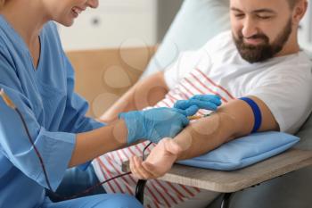 Man donating blood in hospital�
