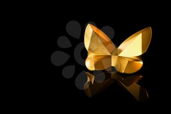 Golden statuette of butterfly on black background�