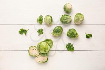 Fresh brussels sprouts on white wooden background, top view�