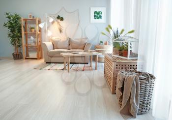 Cozy living room interior in eco style with comfortable furniture and green plants�
