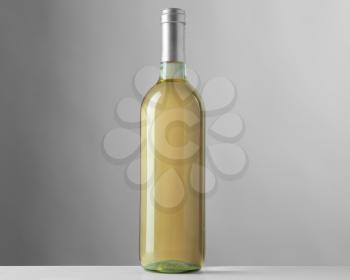 Bottle of white wine on grey background�