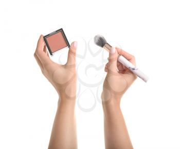 Woman holding blusher with brush on white background�